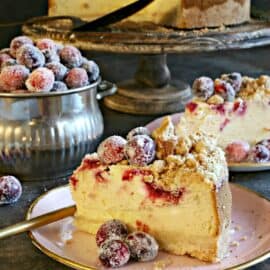 Slice of cranberry cheesecake with sugared cranberries.