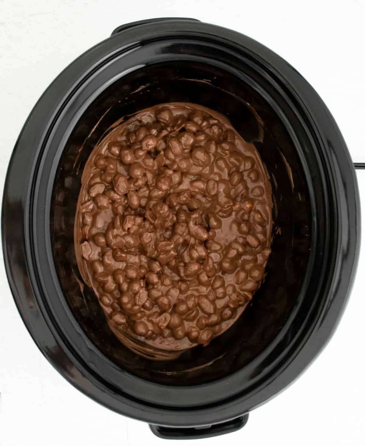 Crockpot with three ingredient chocolate candy inside.