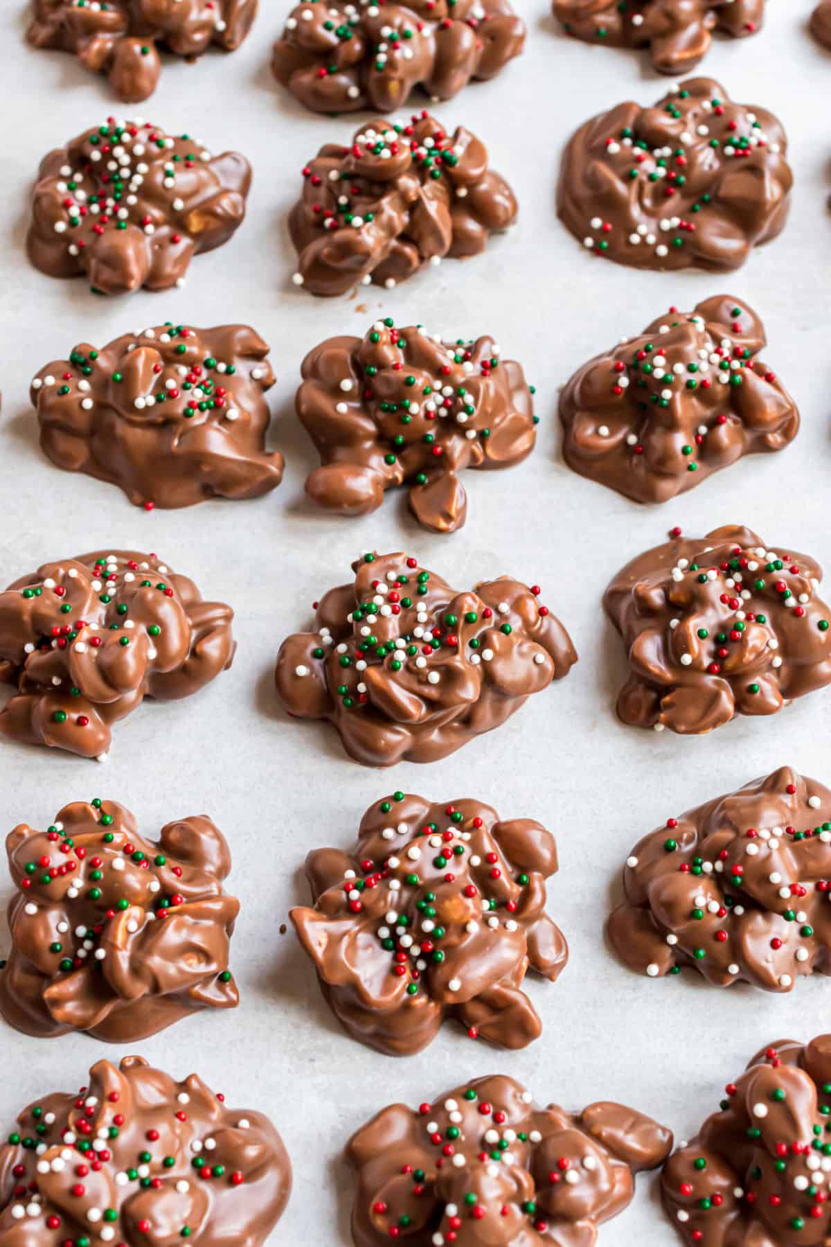 Pieces of chocolate christmas candy on parchment paper.
