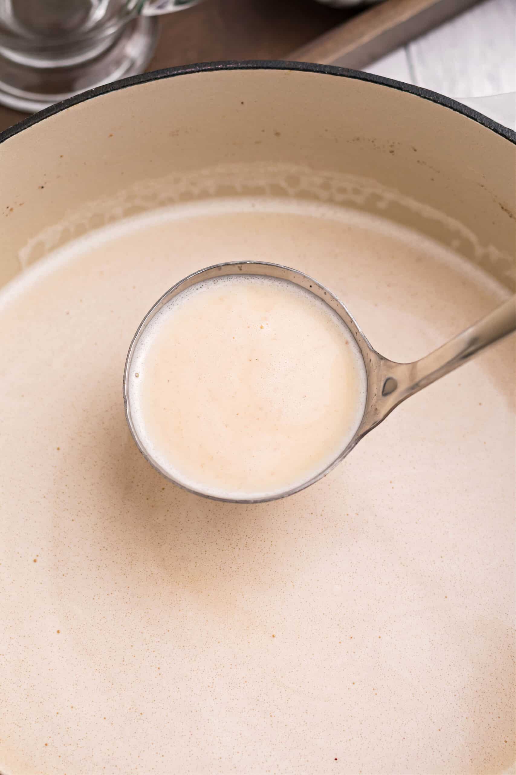 Homemade eggnog in dutch oven with ladle.