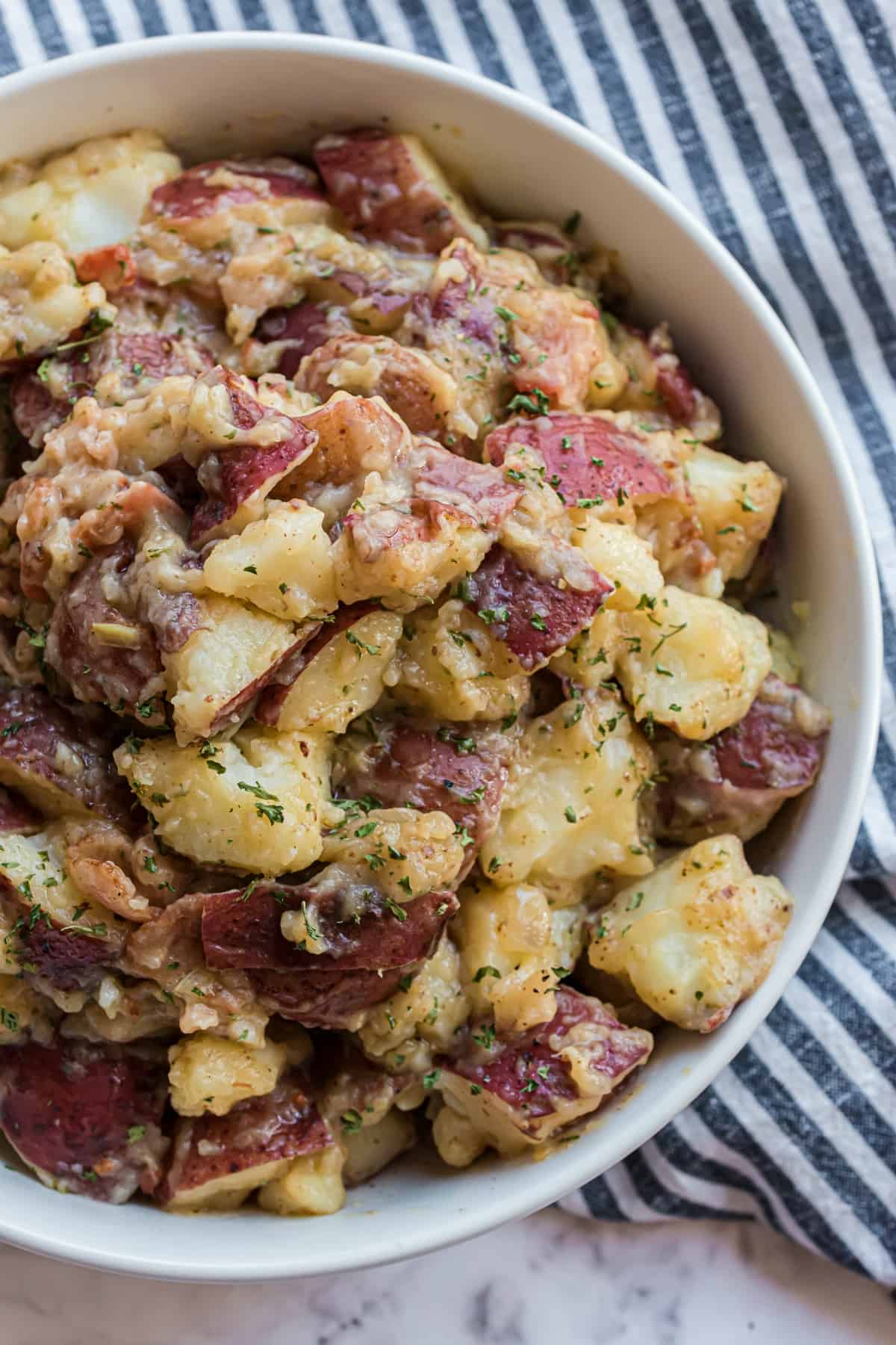 German potato salad served in a white bowl.