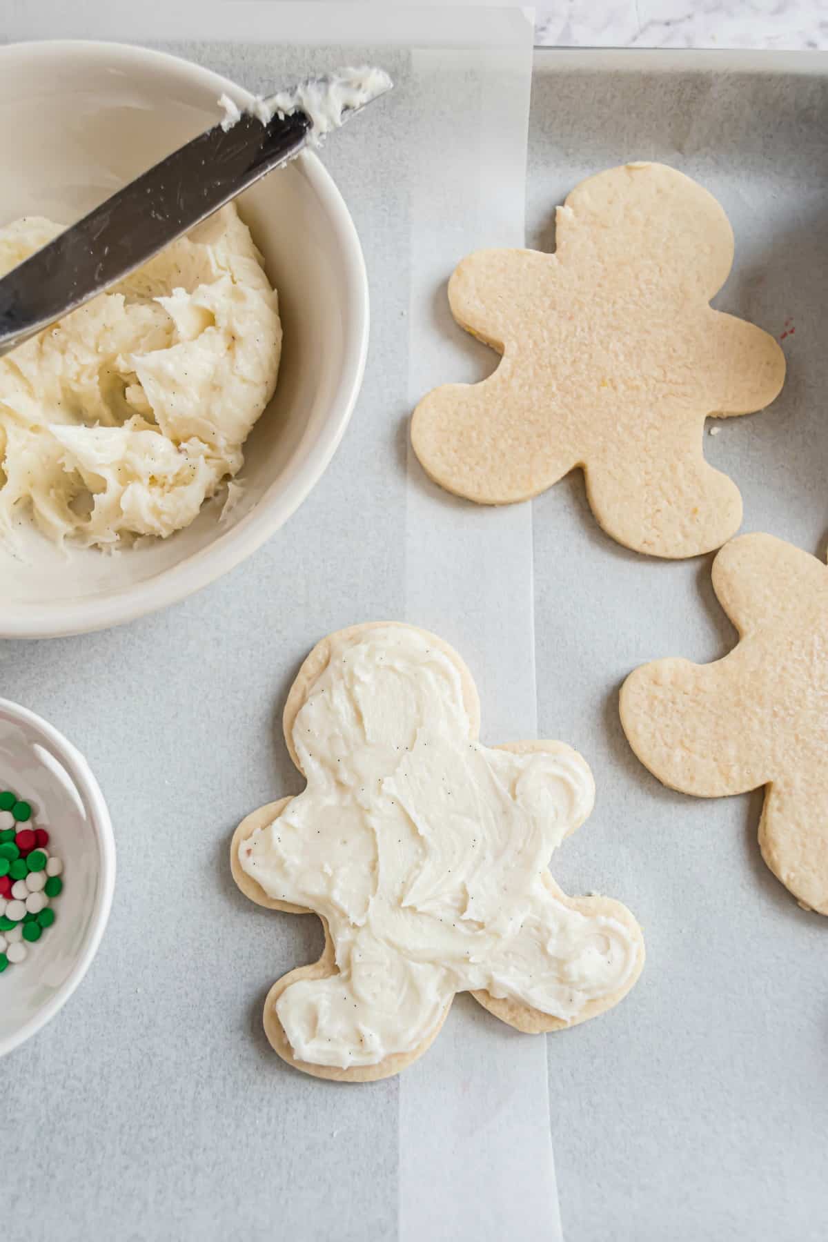 Sugar cookie frosting on gingerbread cut out cookie.