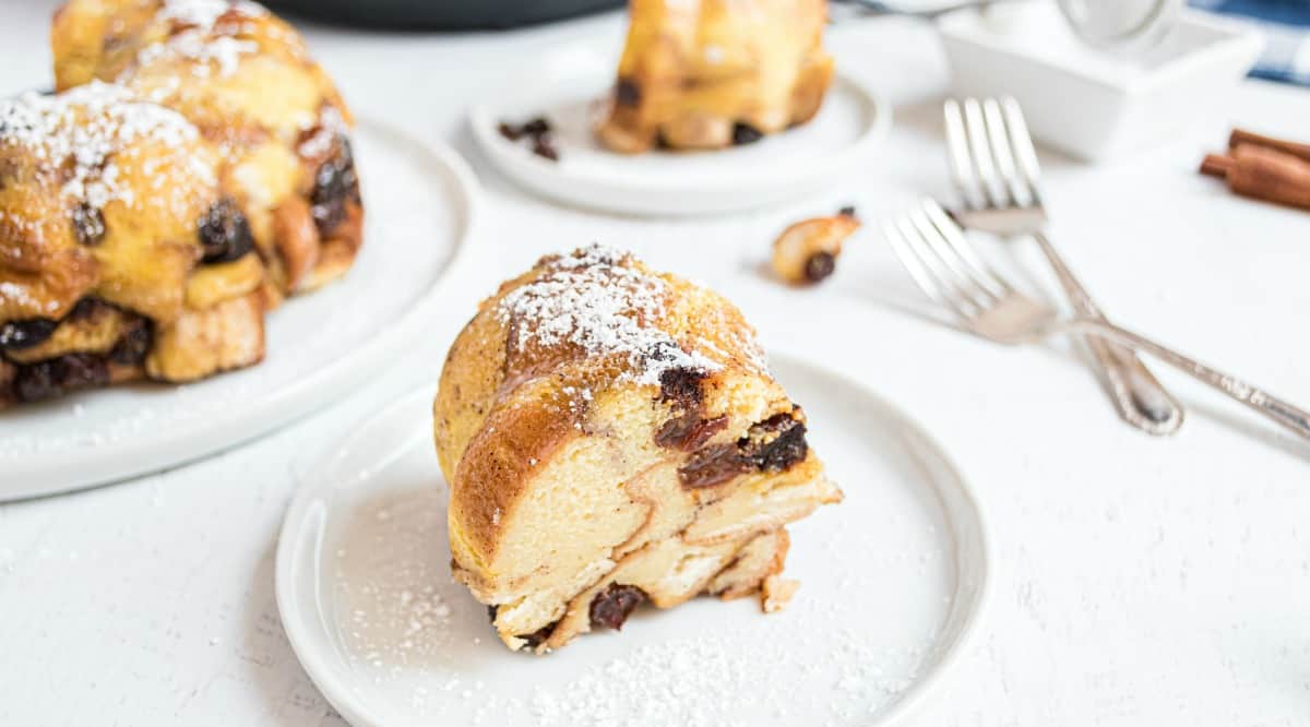 Slice of bread pudding with powdered sugar on top.