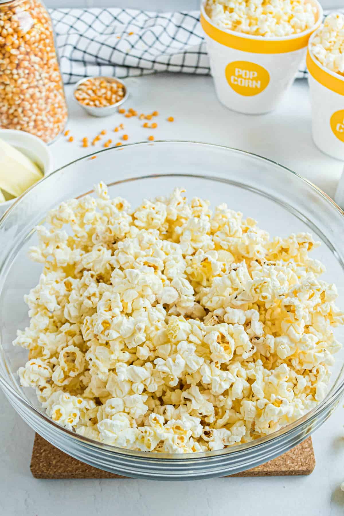 Clear glass bowl with microwave popcorn inside.