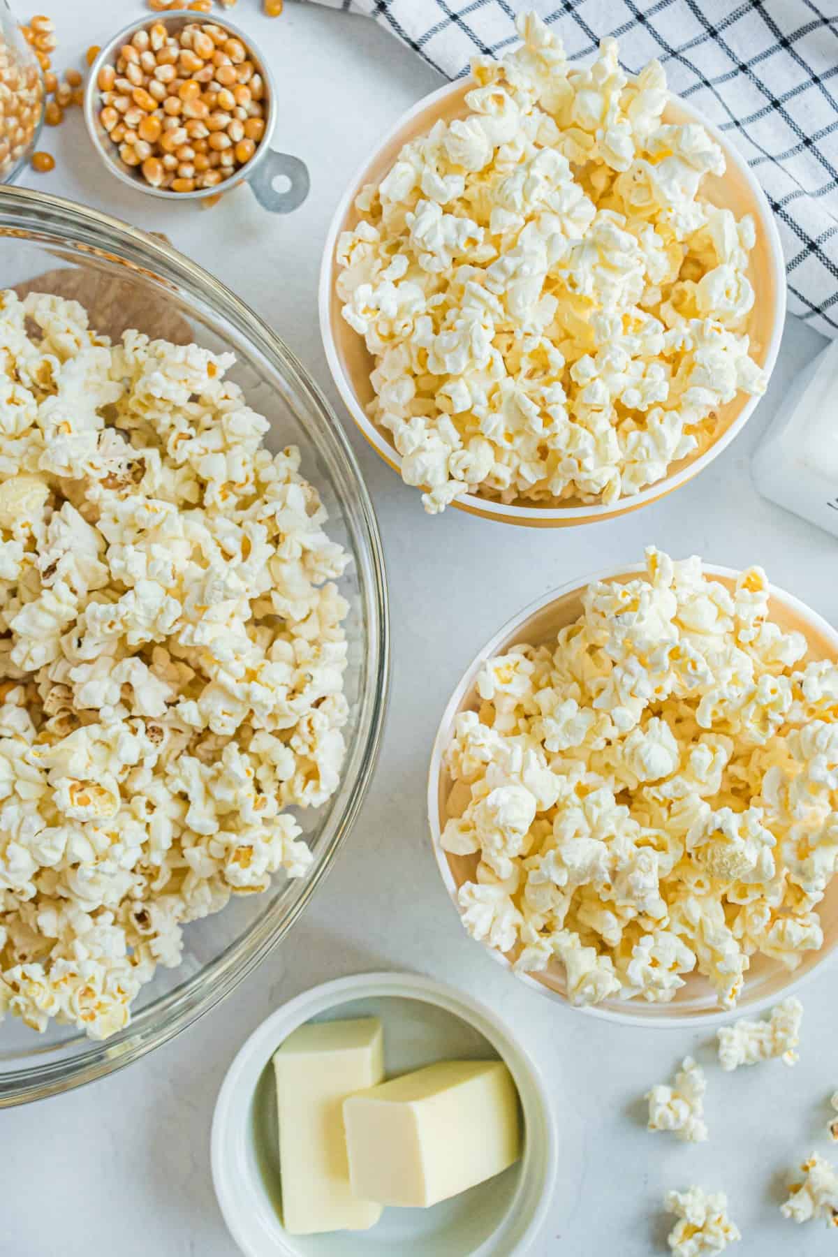 Popcorn served in bowls with a small bowl of butter.