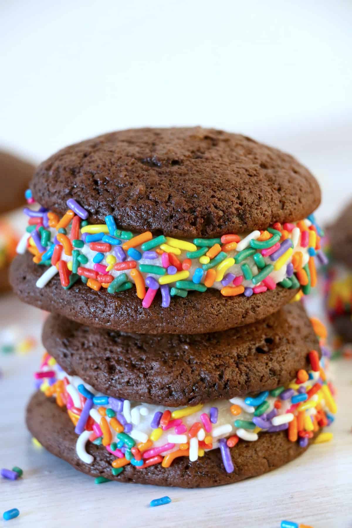 Colorful sprinkles on chocolate whoopie pies.