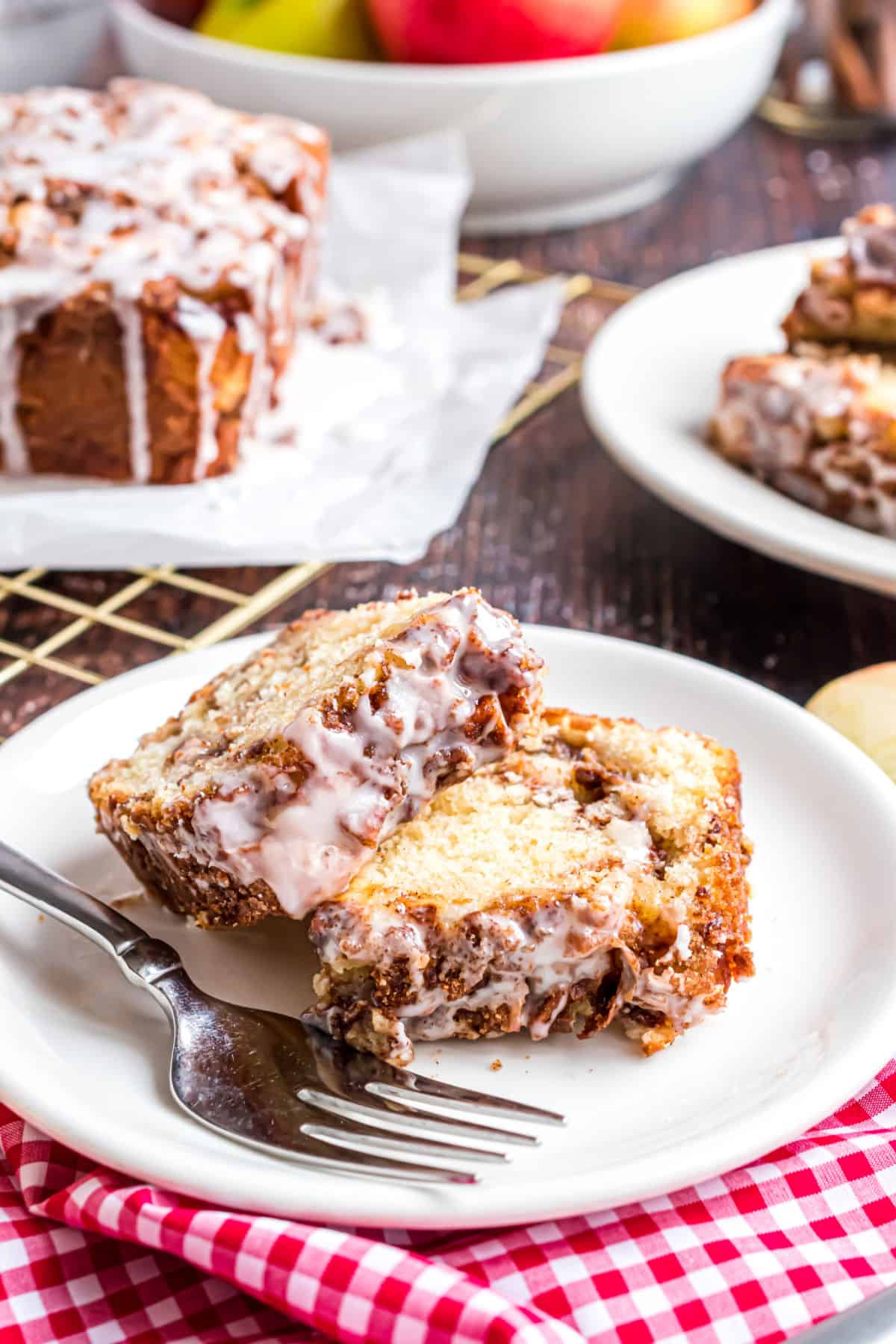 Two slices of apple cinnamon bread on white plate.