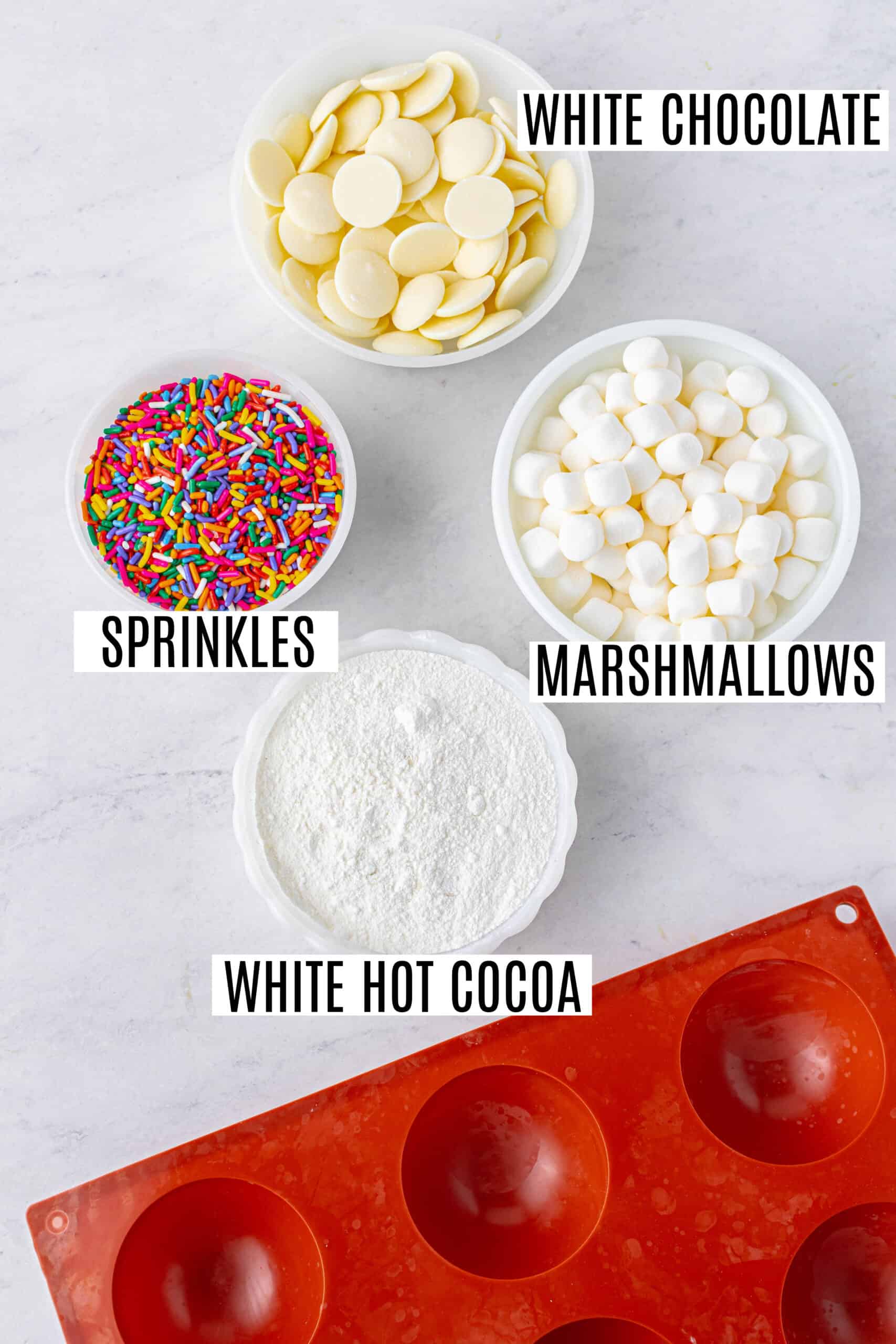 Ingredients needed to make white chocolate hot cocoa bombs with sprinkles.