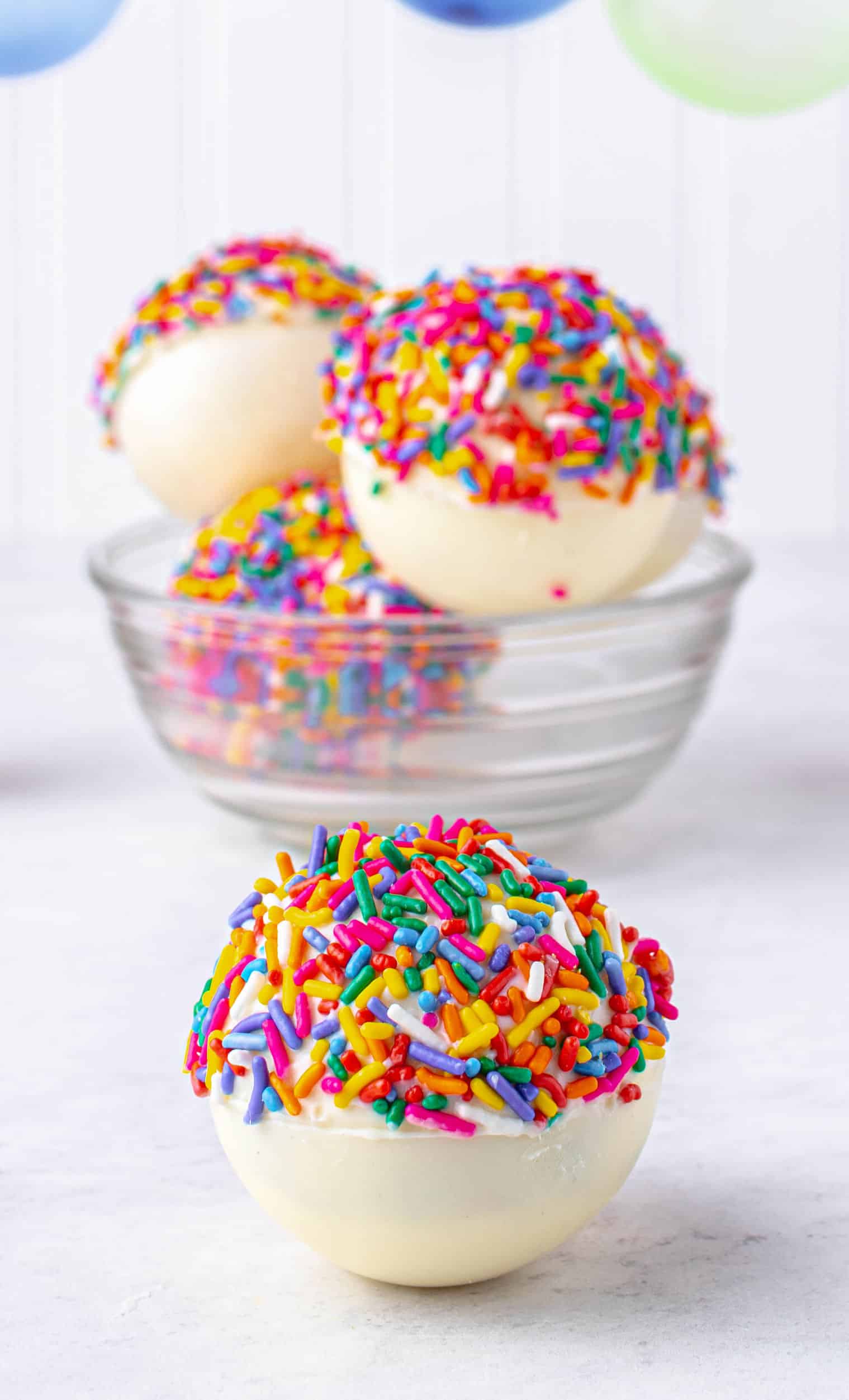 White chocolate hot cocoa bomb with sprinkles.