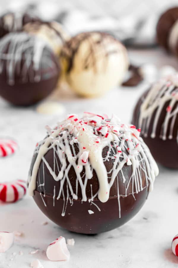 Peppermint hot chocolate bomb with white chocolate drizzle.