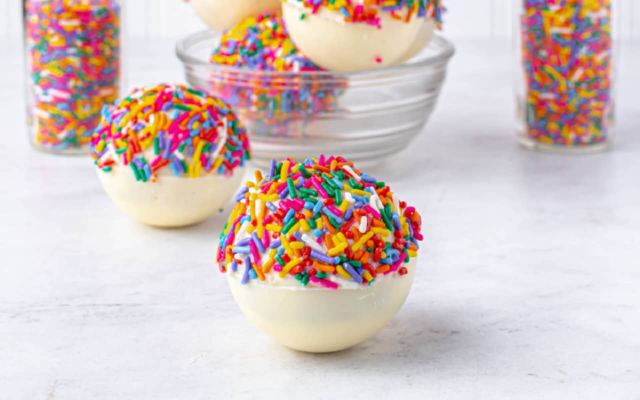 White chocolate hot cocoa bombs with sprinkles.