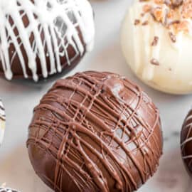 Hot chocolate cocoa bombs on a parchment paper baking sheet ready to use.