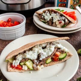 Beef gyro in pita with cucumber, tomato, onion, and tzatziki sauce.