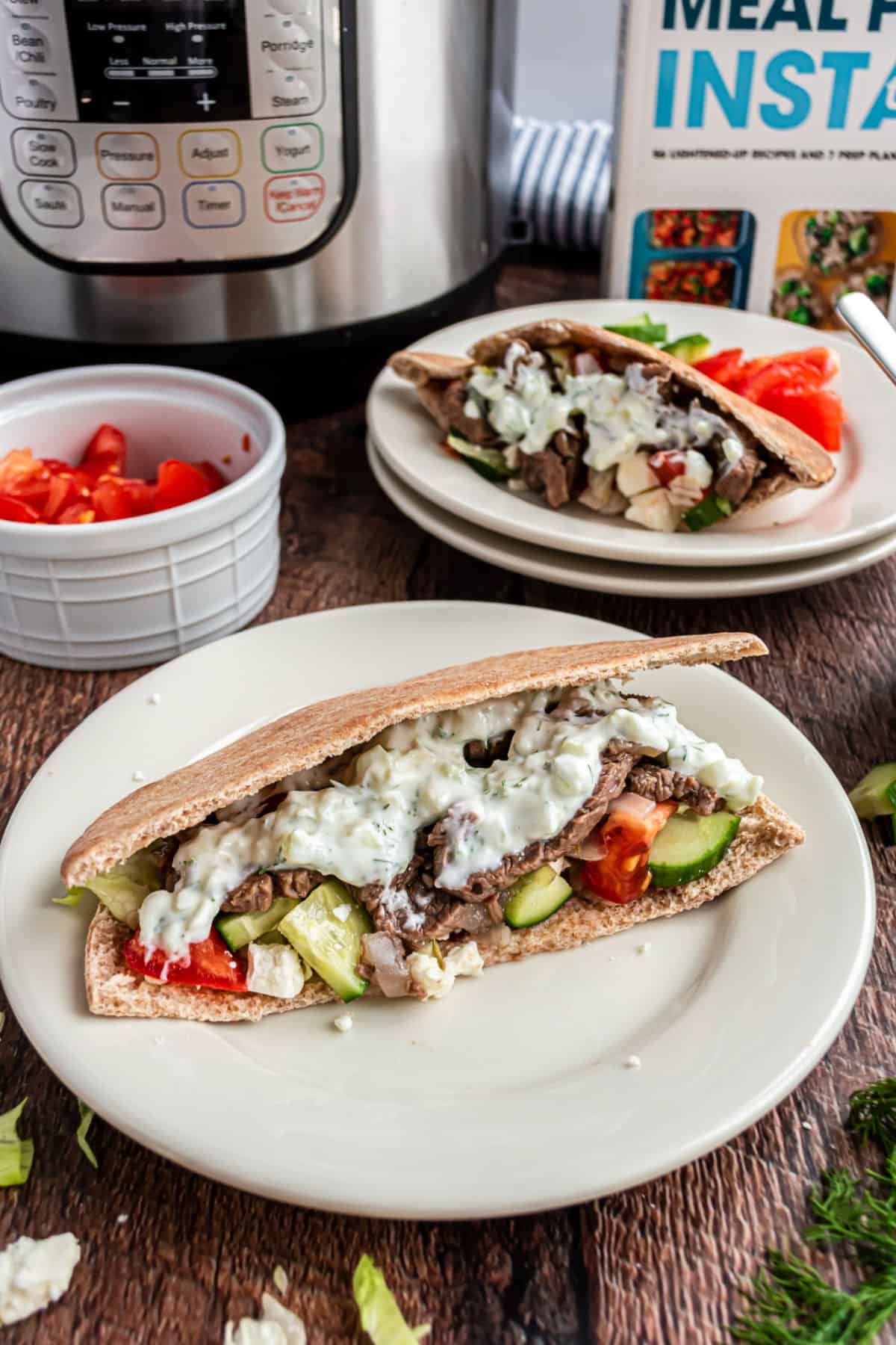 Beef gyro in pita with cucumber, tomato, onion, and tzatziki sauce.