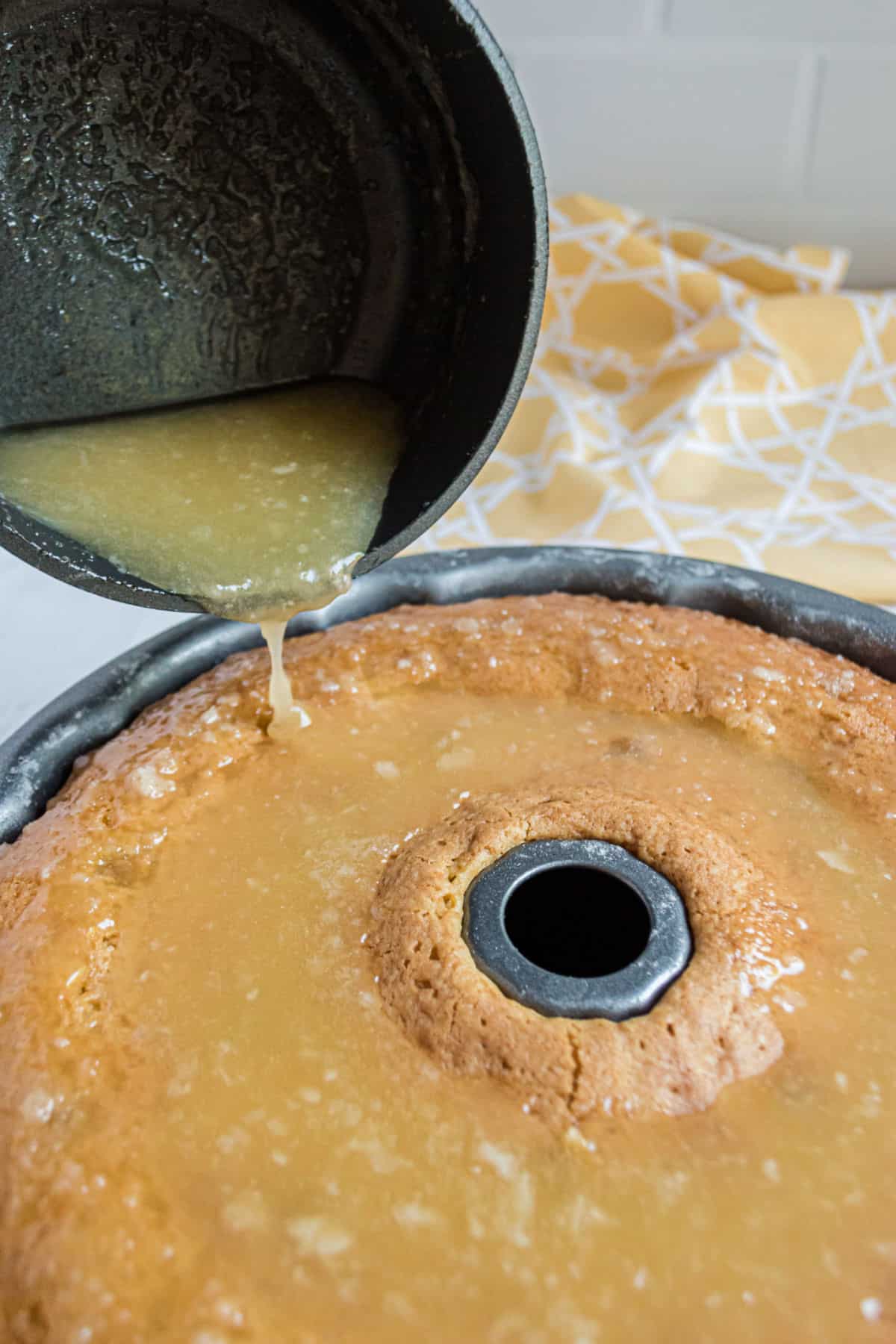 Butter sauce being poured over baked kentucky butter cake.