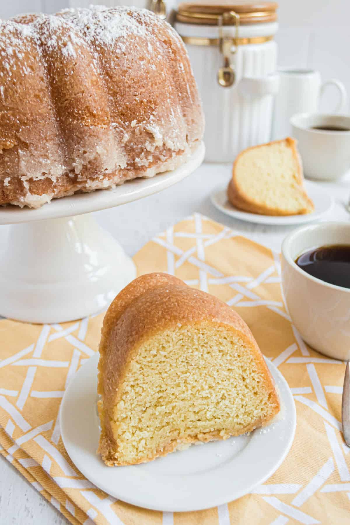 Slice of kentucky butter cake on small white plate.