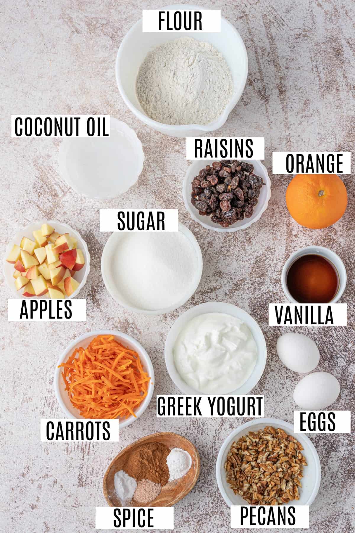 Ingredients needed for morning glory muffins including carrots, pecans, raisins, and apples.