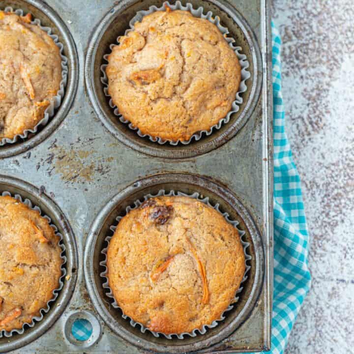 Morning glory muffins in a metal cupcake tin.