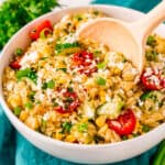 This light and easy Orzo Pasta Salad recipe is tossed with a delicious lemon honey dressing and loaded with fresh corn, cherry tomatoes, cucumbers, and scallions. Feta cheese and a sprinkle of fresh herbs make this side dish complete!