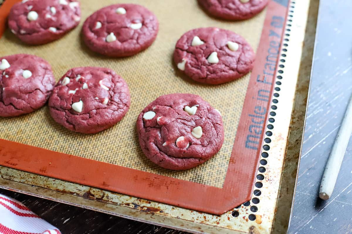 Red velvet cookies baked on a silpat lined cookie sheet.