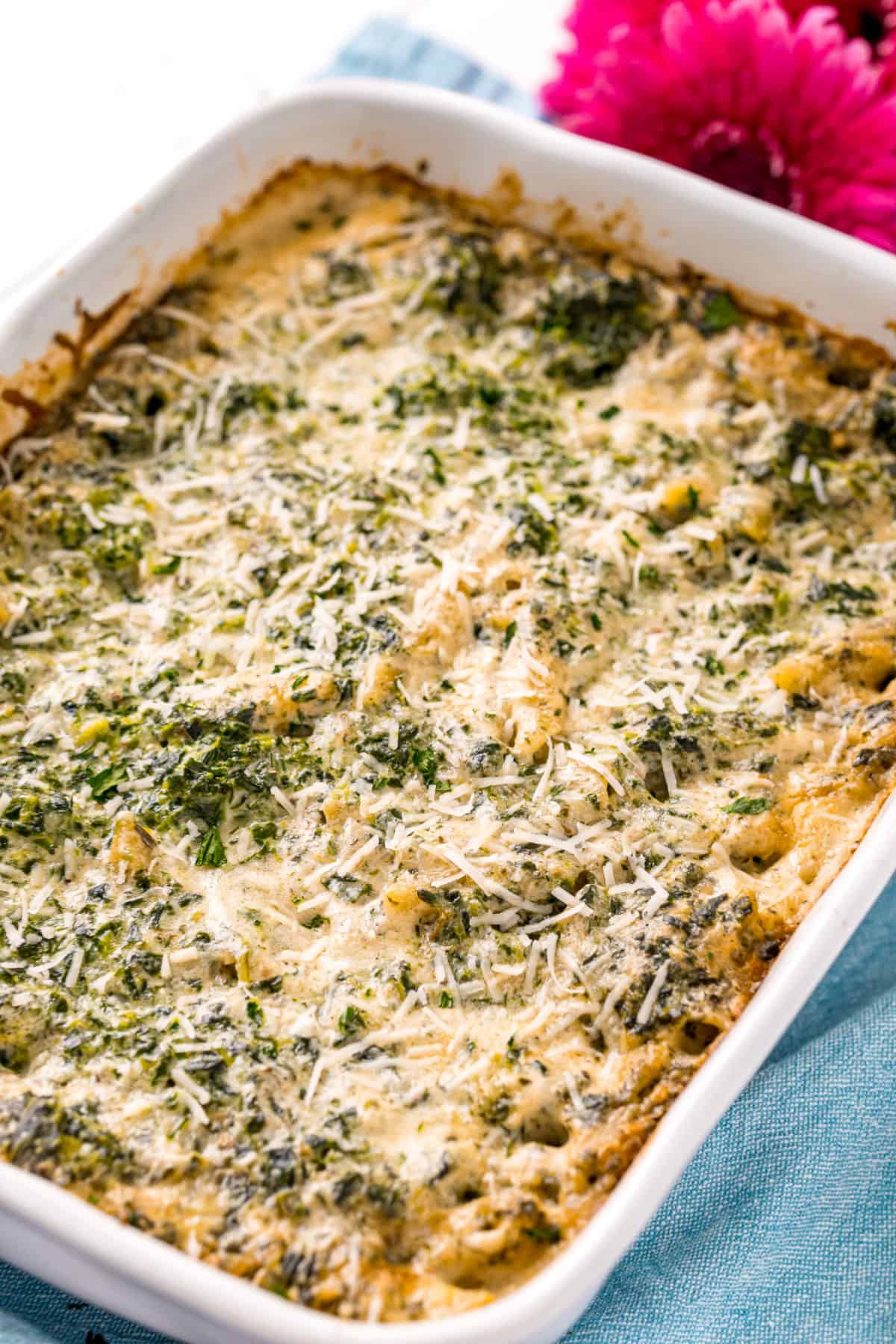 Spinach alfredo baked in a 13x9 white baking dish.