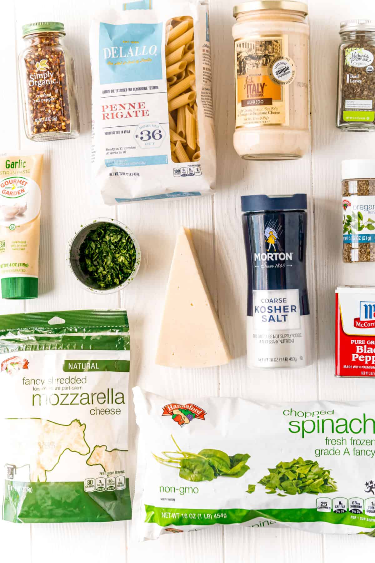Ingredients needed for spinach alfredo pasta dish.