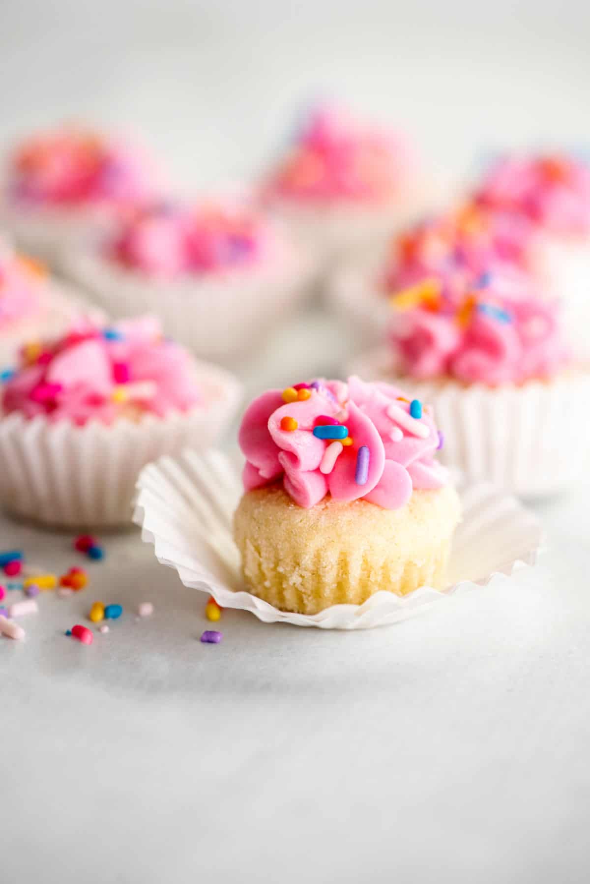 Pink frosted sugar cookies in a cupcake wrapper.