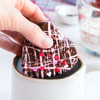 Valentine's Hot Cocoa Bombs - An adorable and delicious way to spread the love! Decorated with pink and white sprinkles and melted chocolate, these bombs create the best hot chocolate for Valentine's Day!