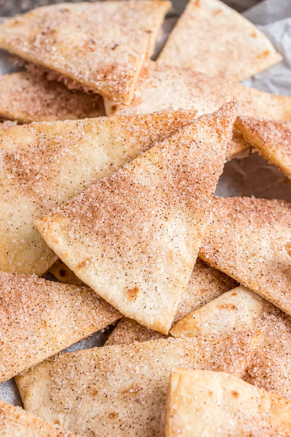 Cinnamon sugar tortilla chips stacked in a bowl.