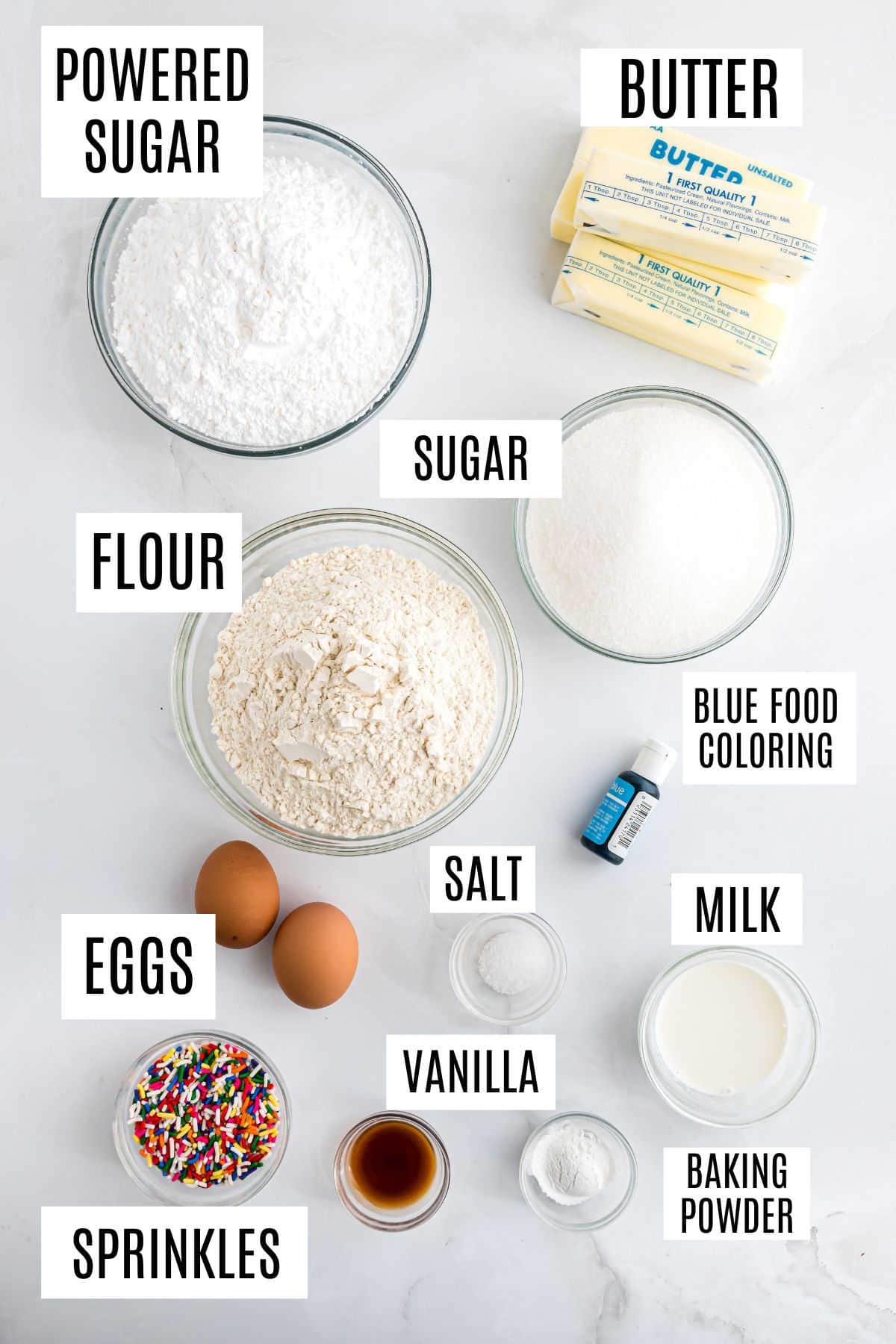 Baking ingredients labeled in bowls: powdered sugar, sugar, flour, butter, eggs, milk, vanilla, salt, sprinkles, and baking powder—everything you need for delicious frosted sugar cookie bars.