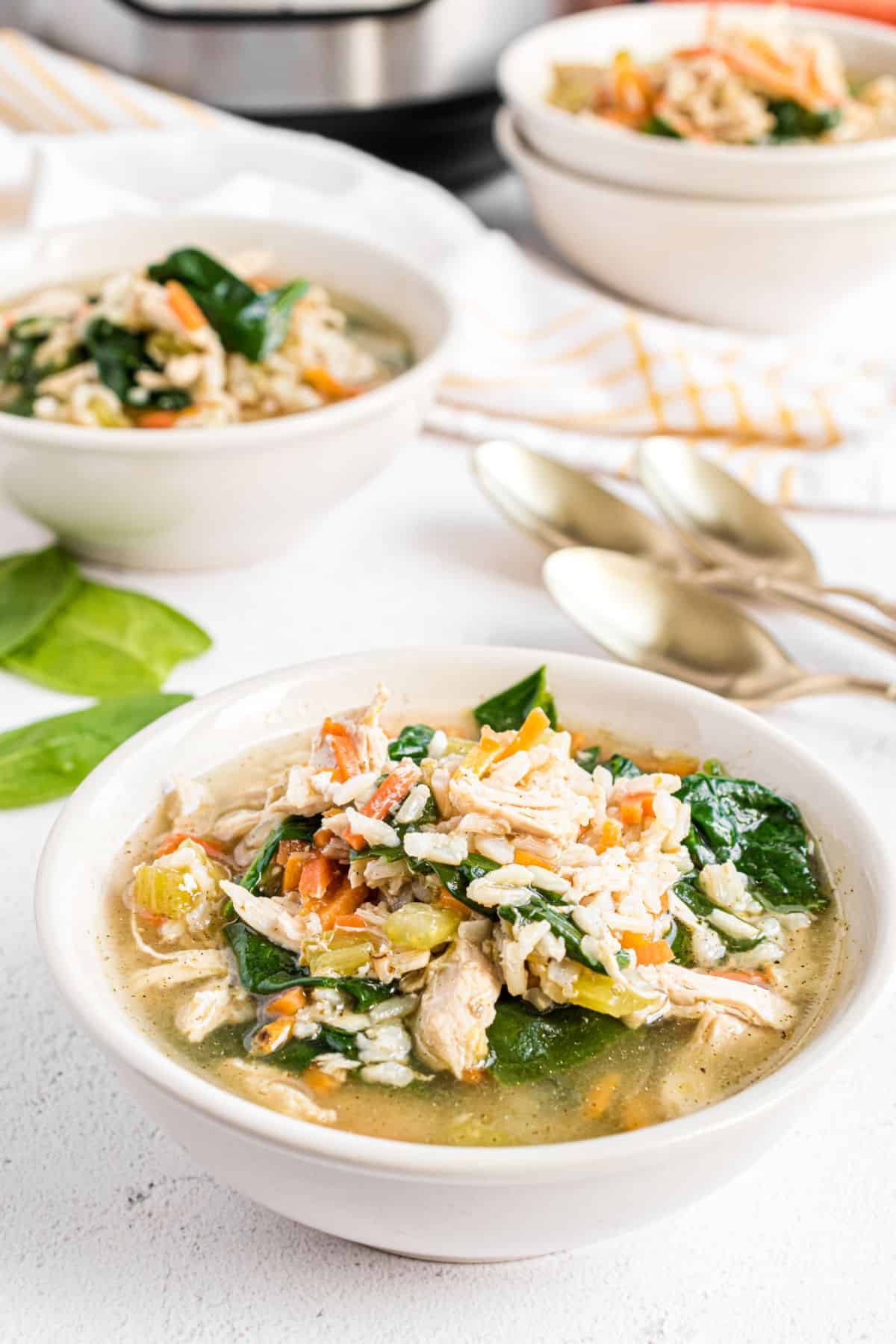 Soup bowl with chicken and rice soup with spinach.