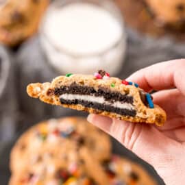 Oreo stuffed chocolate chip cookie with a bite removed to show filling.