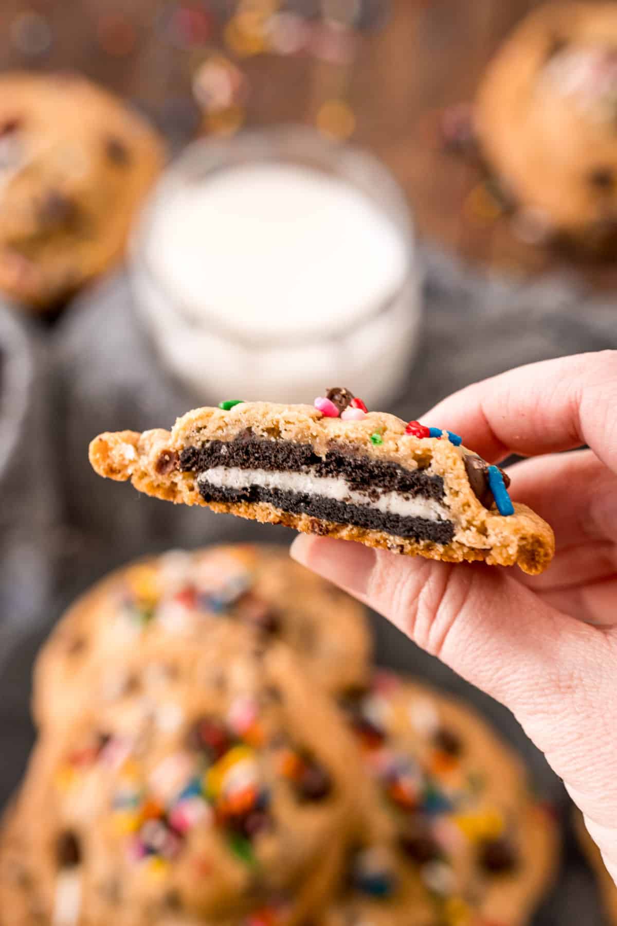Oreo stuffed chocolate chip cookie with a bite removed to show filling.
