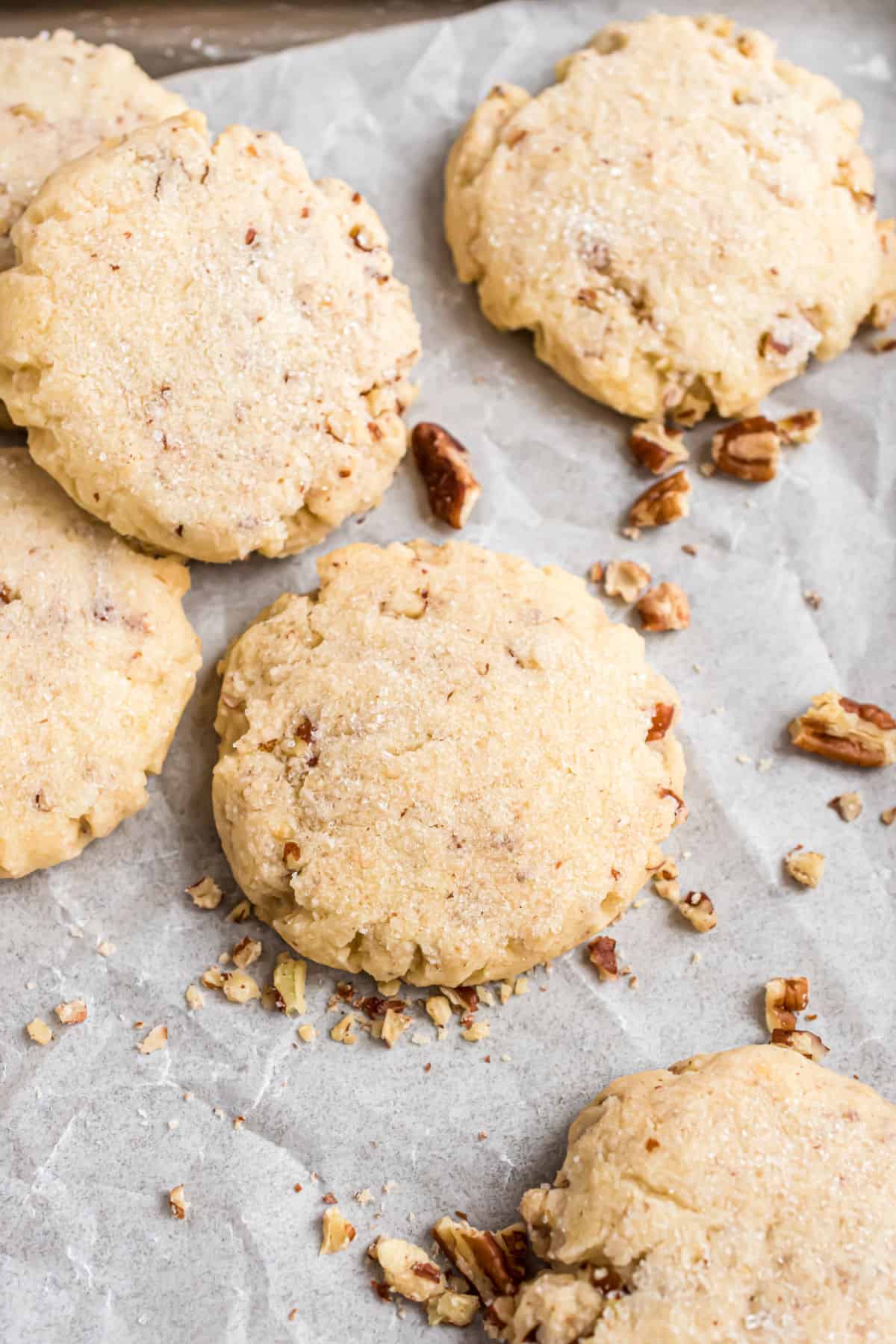 Pecan sandies cooled on parchment paper.