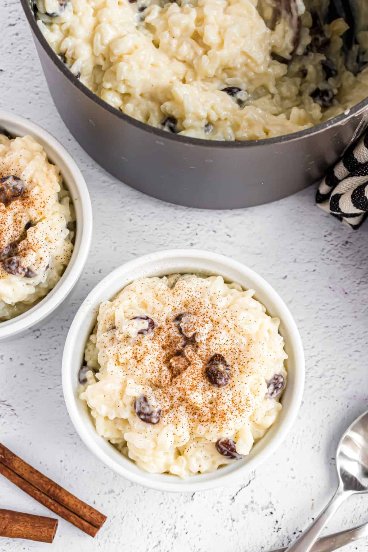 Rice pudding served in small bowls and sprinkled with cinnamon.