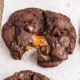 Chocolate cookies with a caramel center, oozing out of middle.