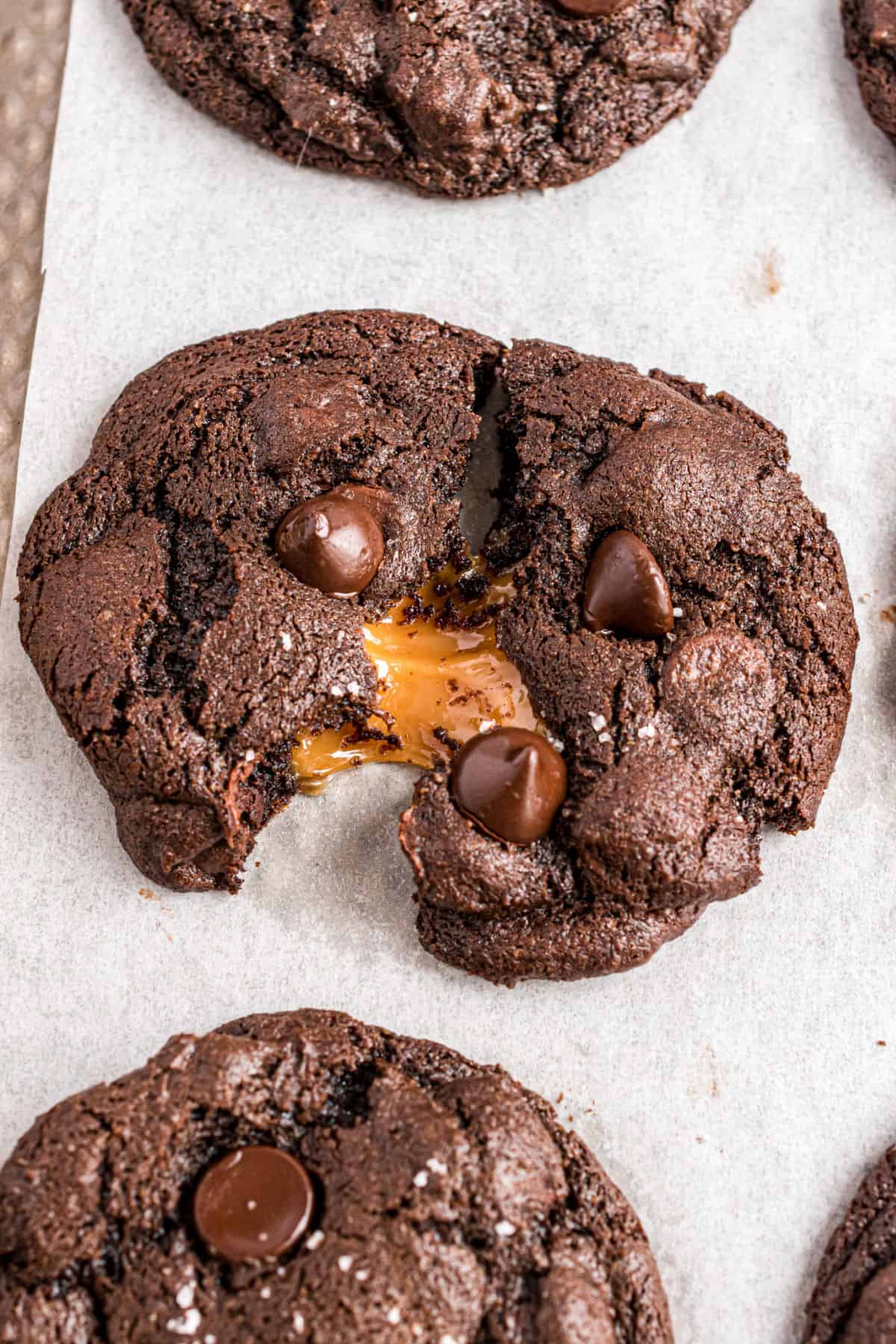Chocolate cookies with a caramel center, oozing out of middle.