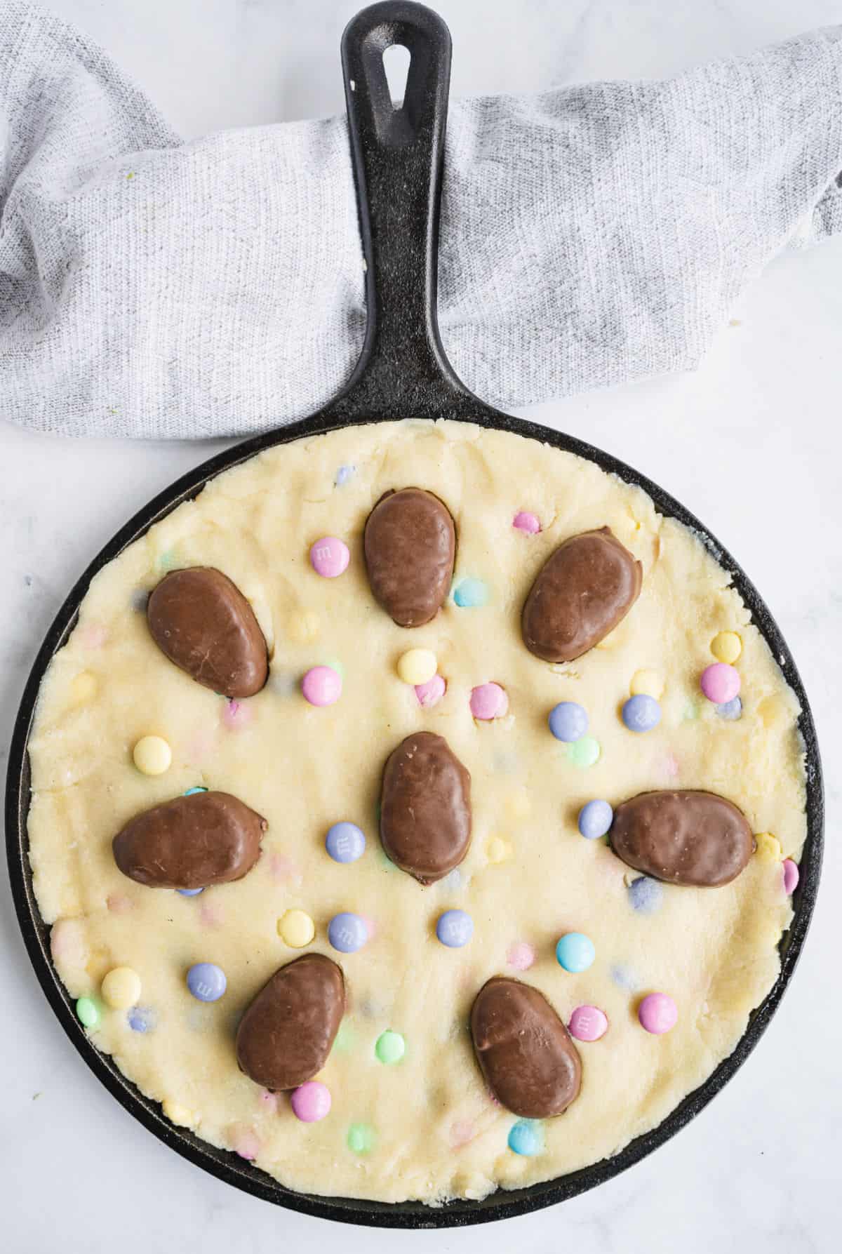 Unbaked skillet sugar cookie with reese's eggs on top.