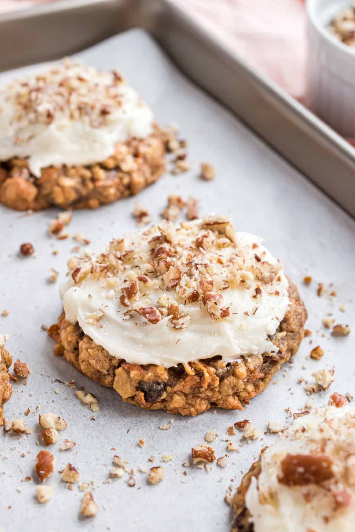 Carrot cake cookies on parchment paper lined cookie sheets.