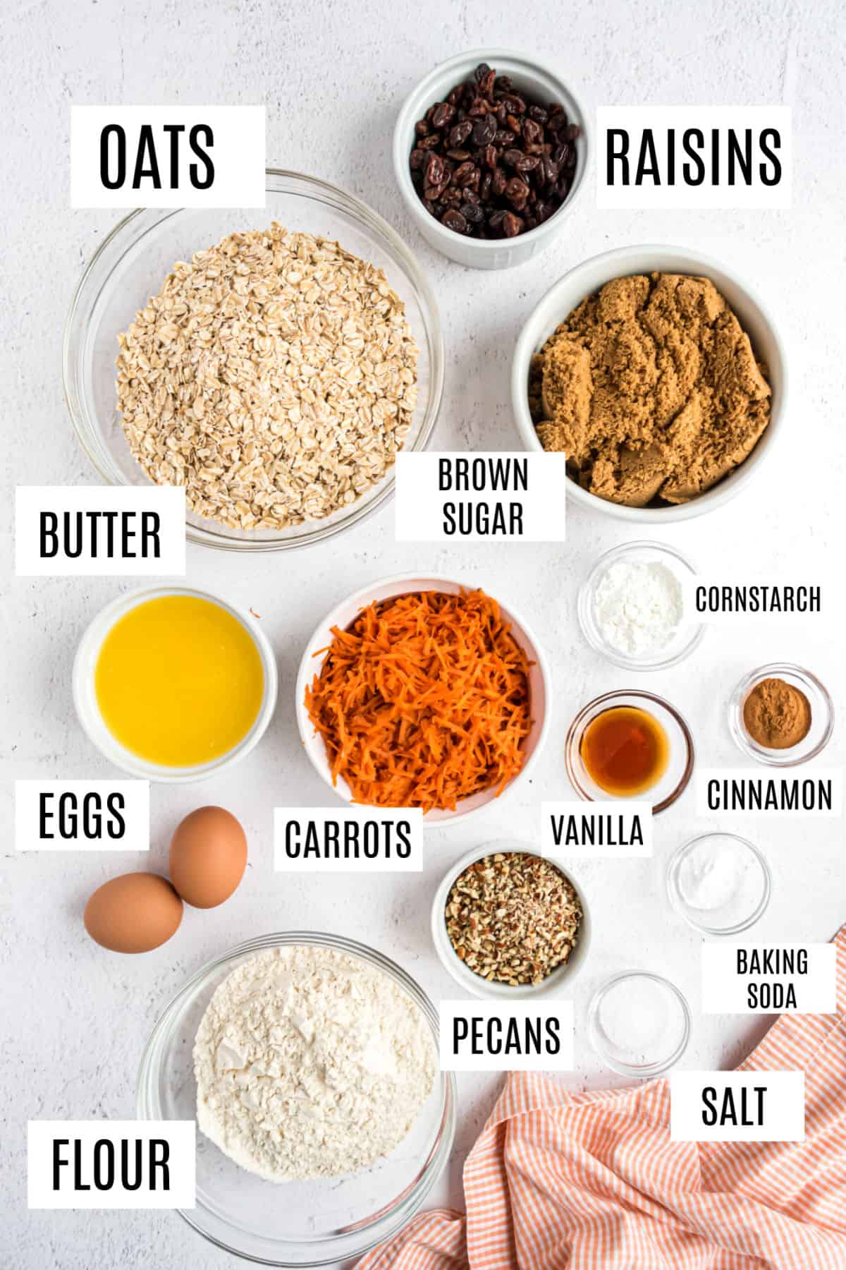 Carrot cake cookie ingredients on white table.