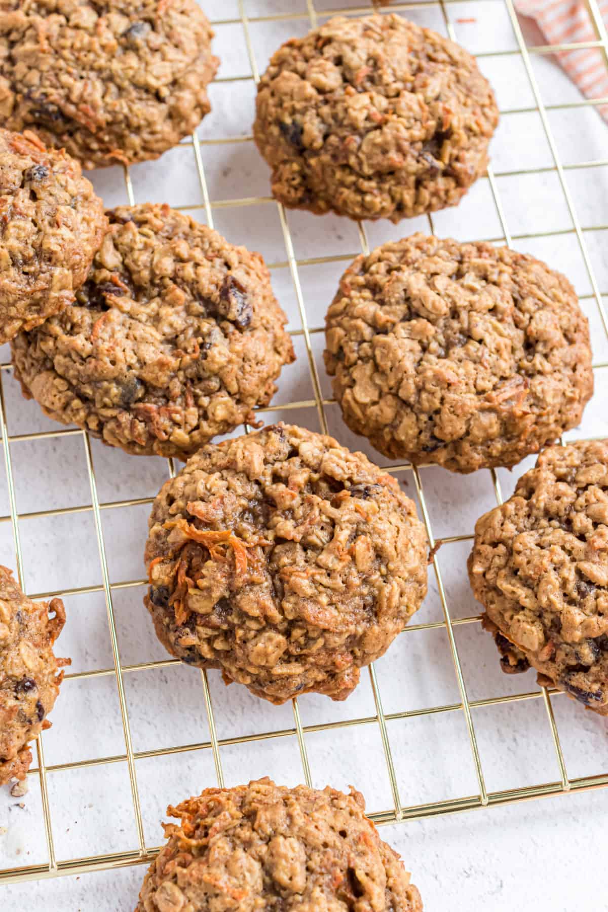 Unfrosted carrot cake cookies on wire cooling rack.