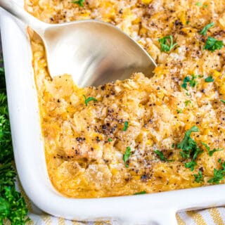 Baked corn casserole with a spoon.