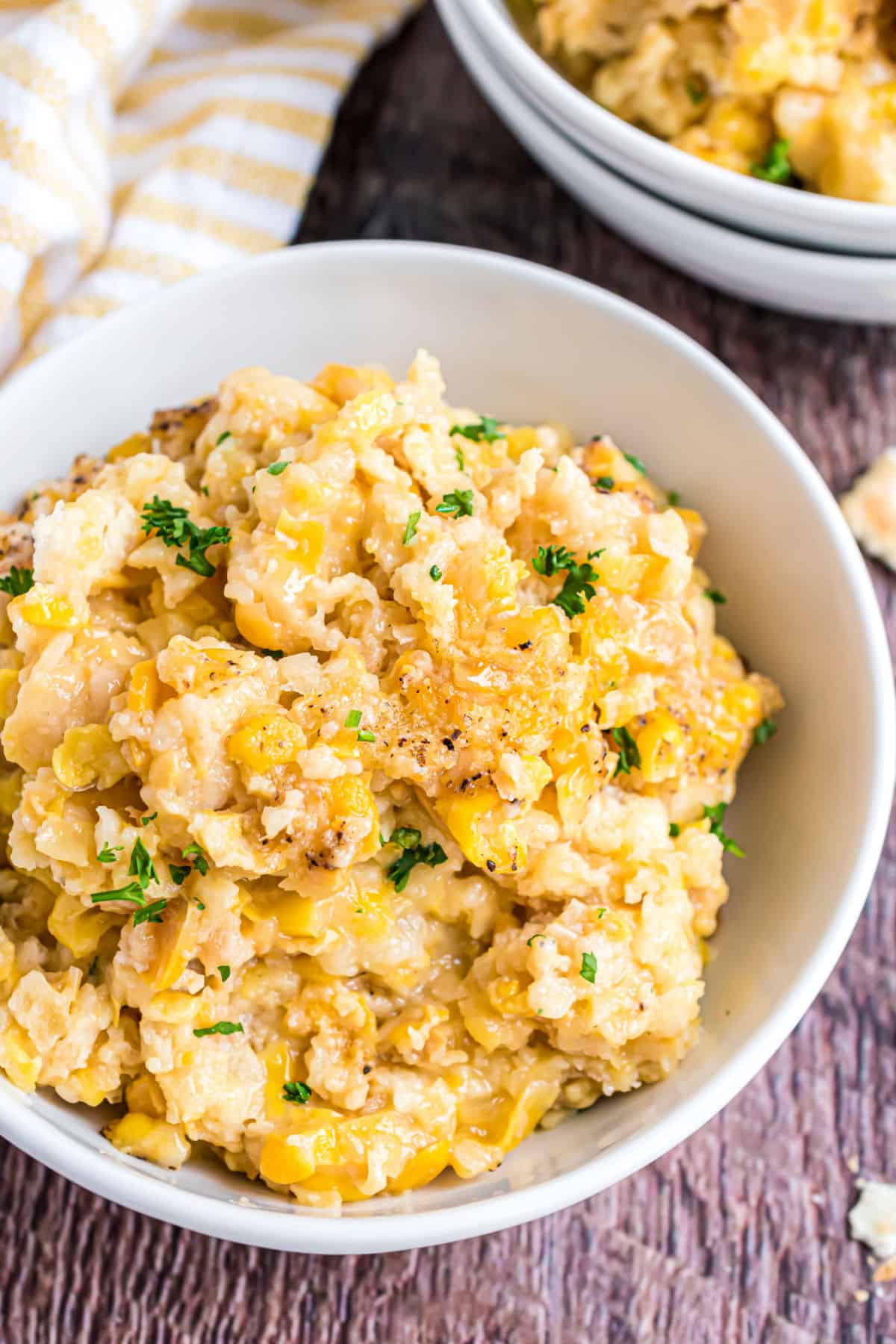 Corn casserole in a white bowl to serve.