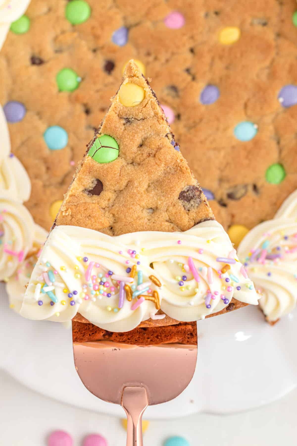 Easter cookie cake with frosting and pastel candies.