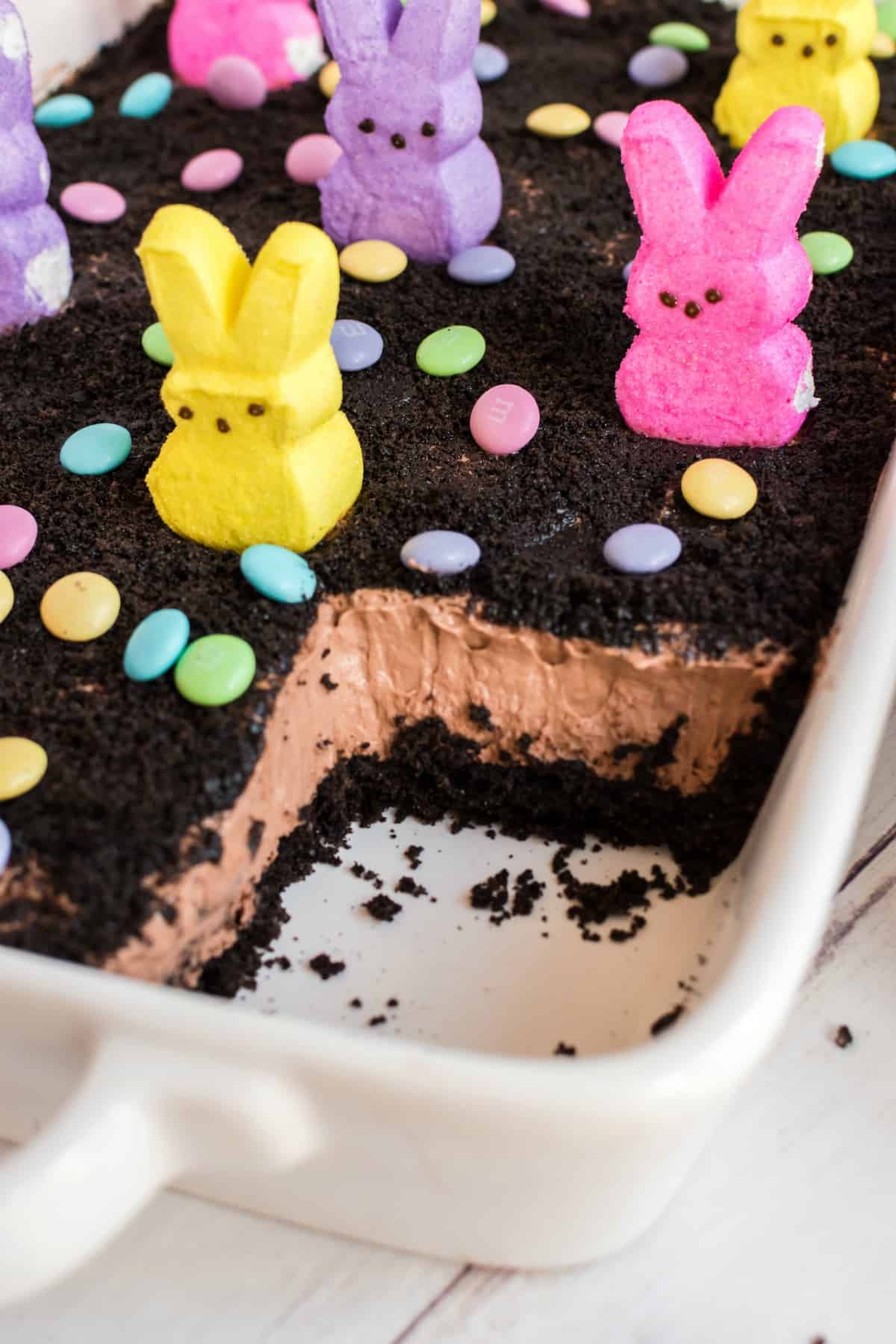 Easter dirt cake in a 13x9 baking dish with one slice removed.