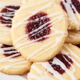 Thumbprint cookies with raspberry jam and vanilla icing drizzle.