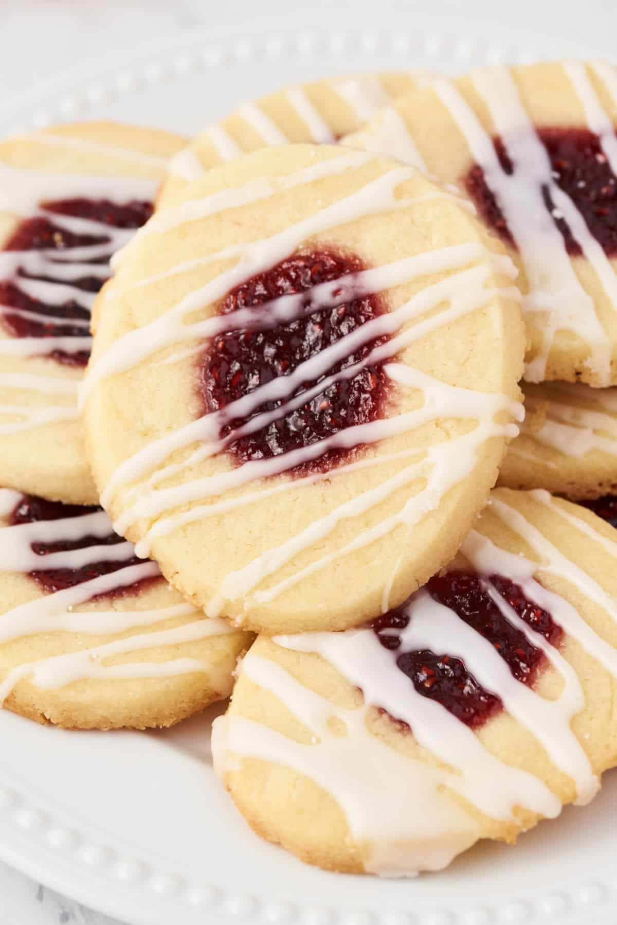 Thumbprint cookies with raspberry jam and vanilla icing drizzle.