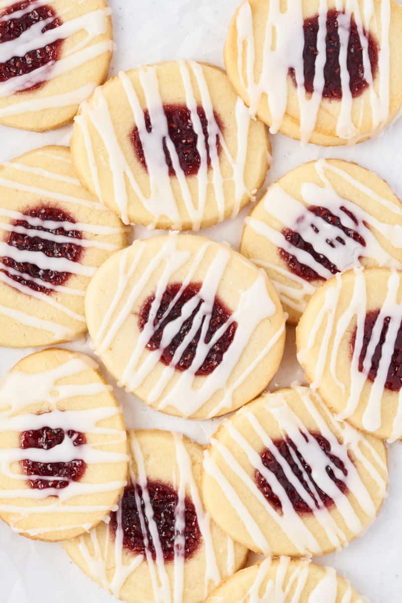 Jam thumbprint cookies stacked on top of each other.