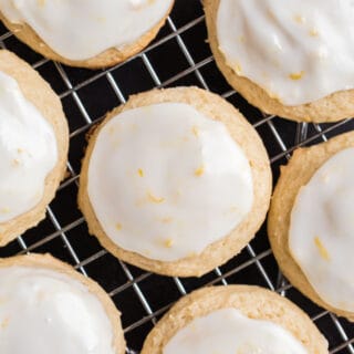 Lemon iced ricotta cookies on a wire cooling rack.