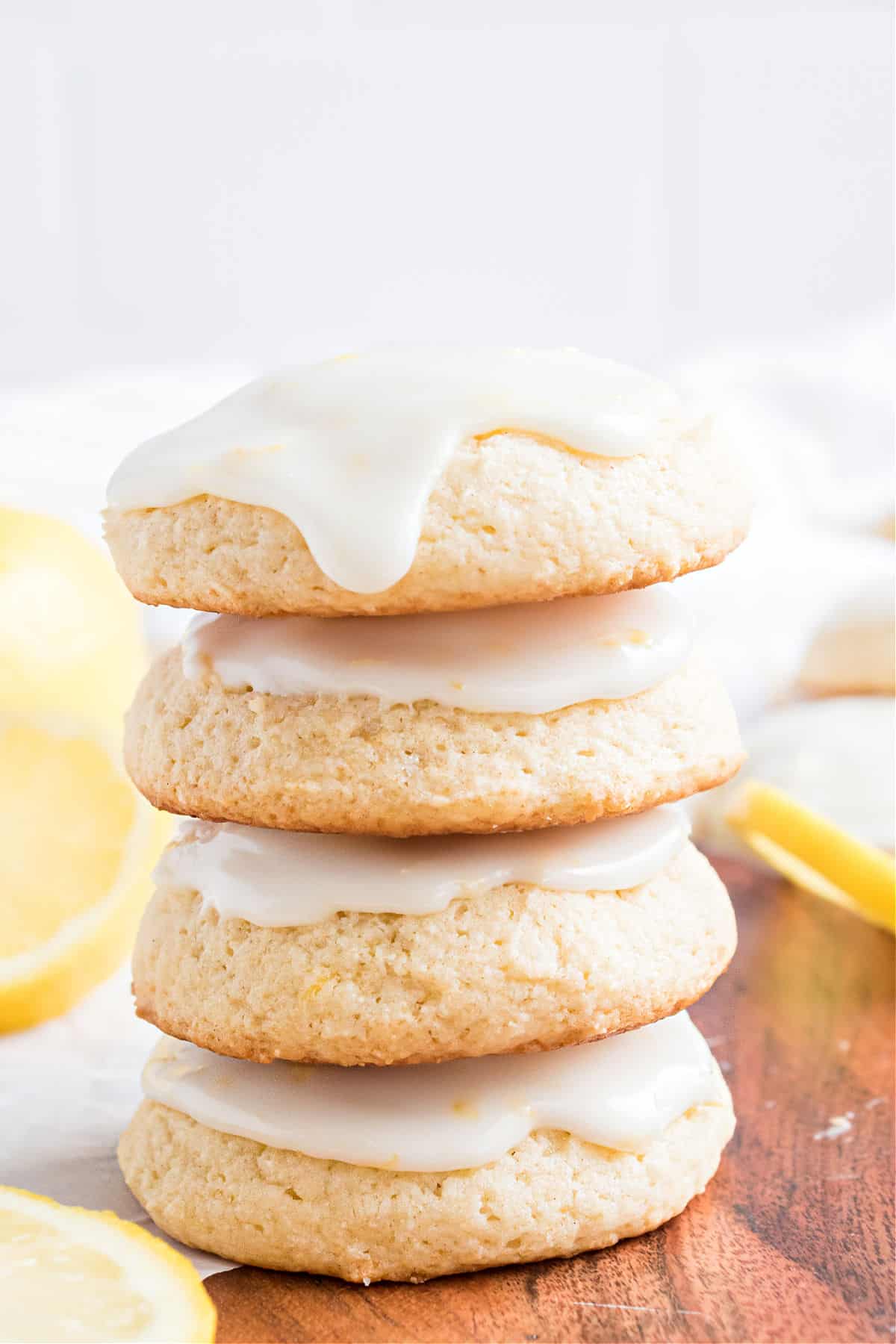 Four lemon ricotta cookies stacked on top of eachother.